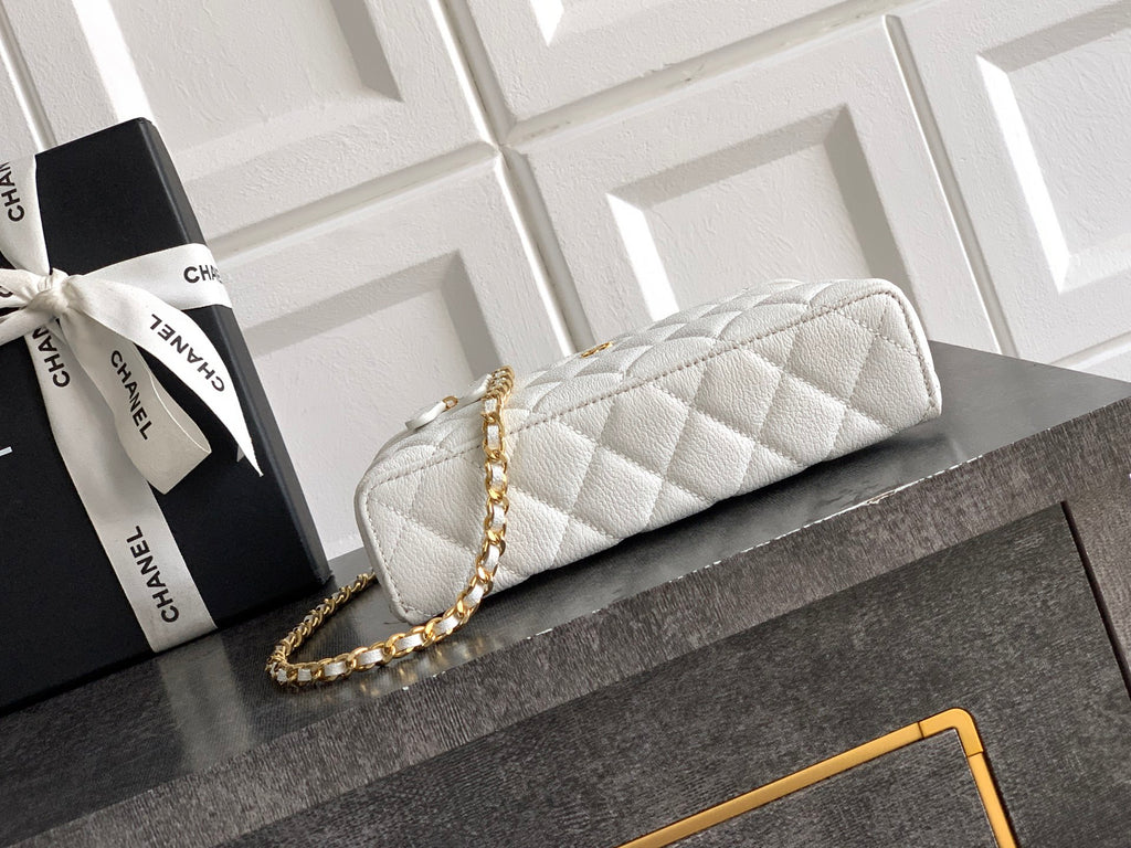 White quilted handbag with gold zipper and gold chain strap