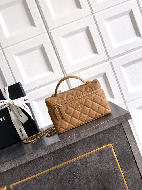 Chanel quilted handbag with top handle, gold chain strap, tan leather-look exterior.