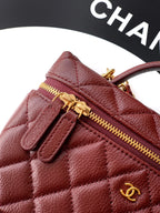 Chanel quilted leather bag close-up in burgundy with gold zipper and CC charm