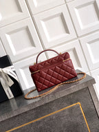 Chanel quilted top-handle handbag in burgundy leather with gold chain strap