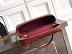 Chanel quilted handbag in burgundy leather with gold zipper opening and lining