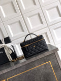 Black quilted handbag with gold chain strap and top handle, zip closure.