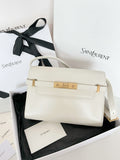 Cream leather handbag with gold clasp and shoulder strap, front flap closed