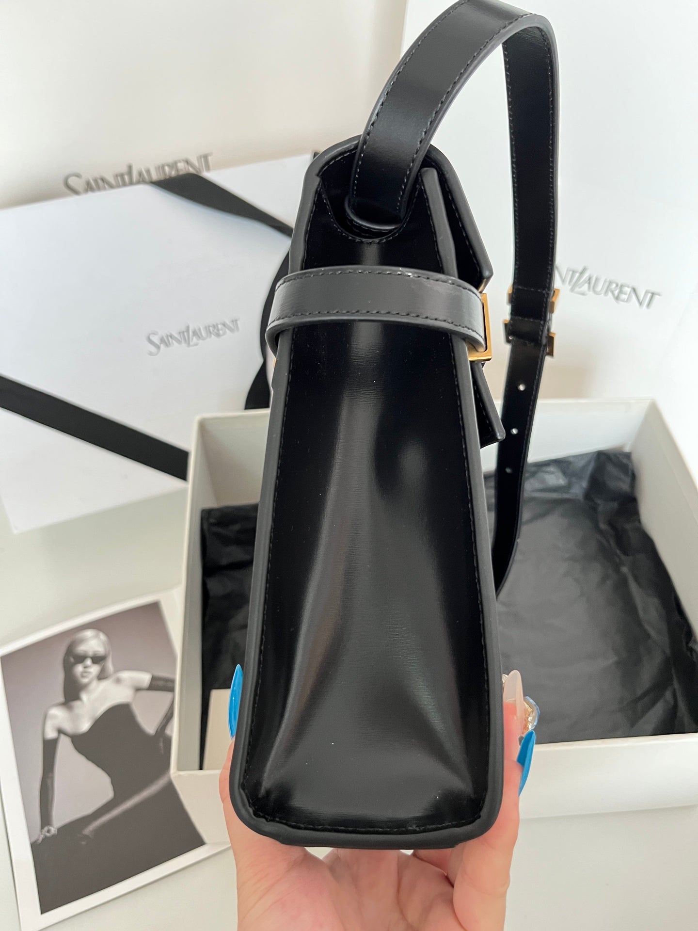 YSL handbag vertical view with top handles, dark leather, gold-tone accents