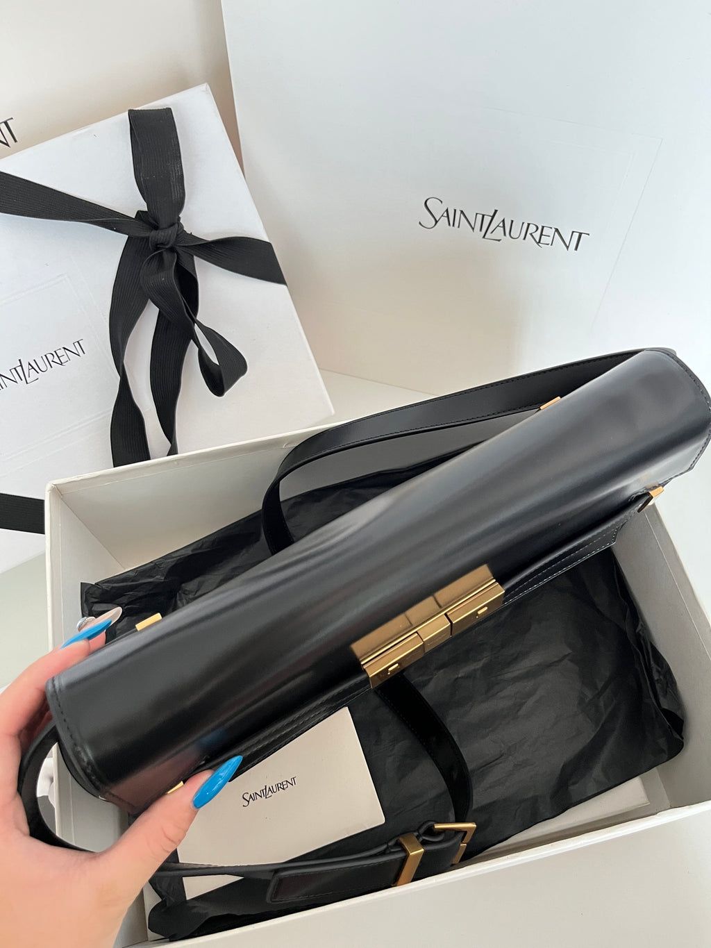 YSL handbag with long shoulder strap, dark leather, gold-tone bar detail
