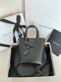 YSL dark gray leather tote bag with top handles, bow charm, and gold hardware