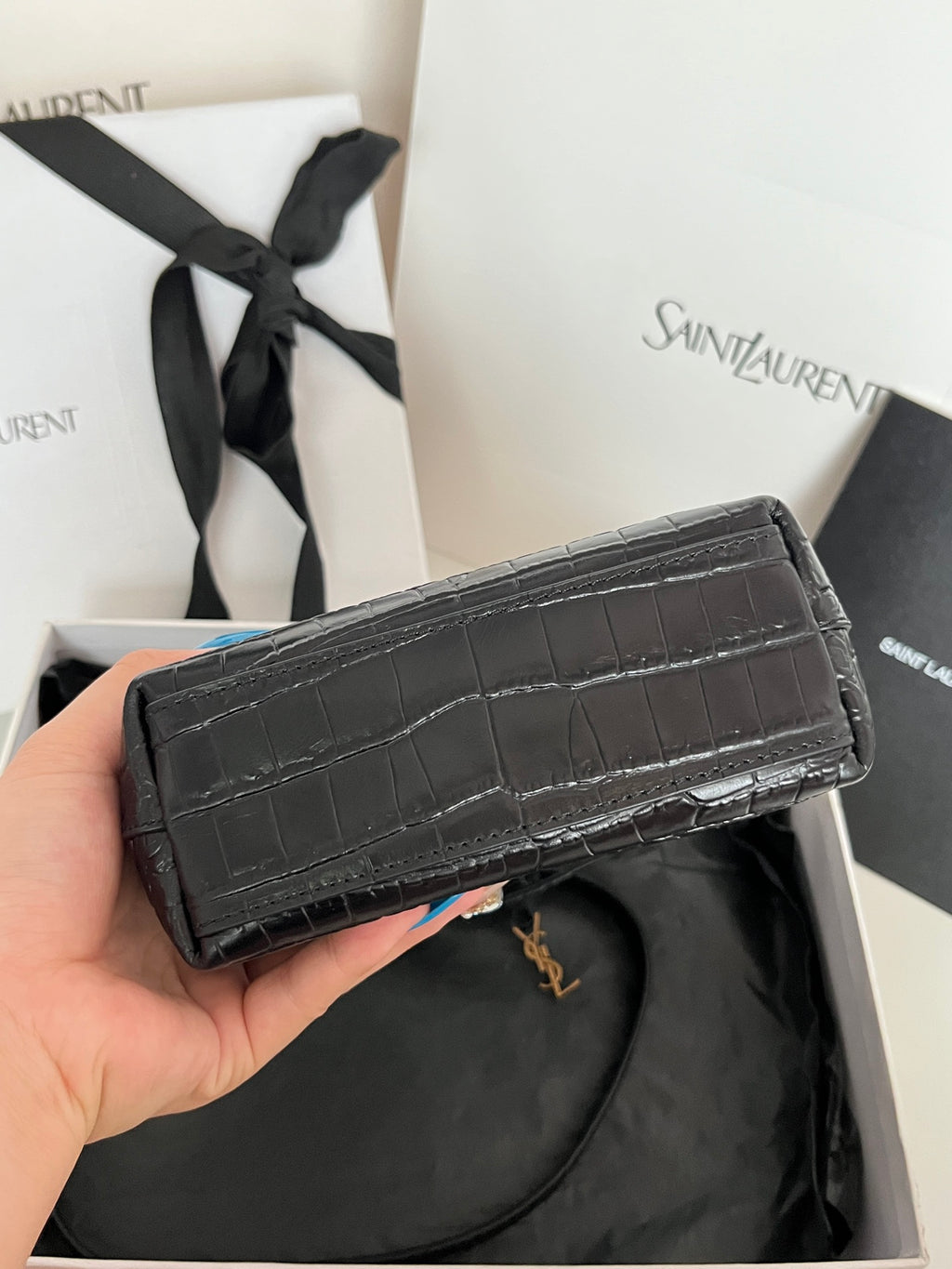 Black croc-embossed leather flap clutch with top handle and gold-tone logo hardware