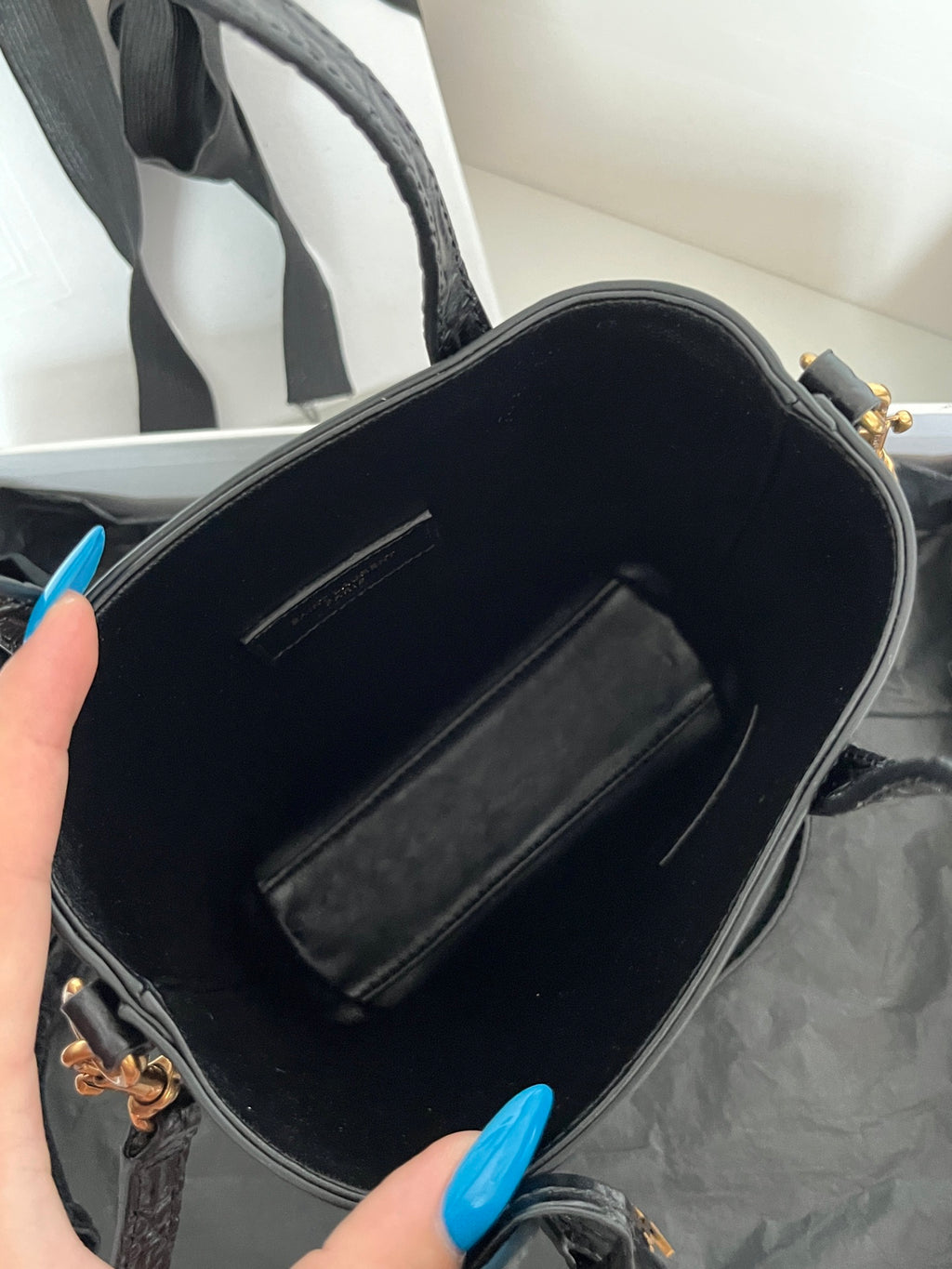 Black leather tote bag interior with zip pocket and stitched lining, open top