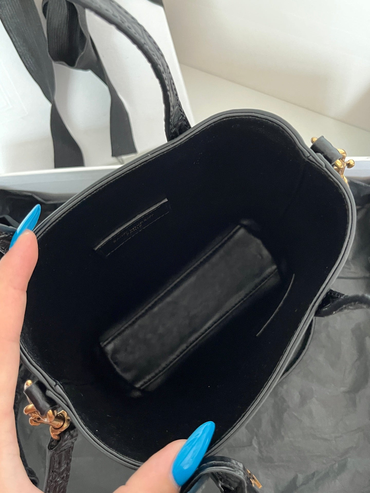 Black leather tote bag interior with zip pocket and stitched lining, open top
