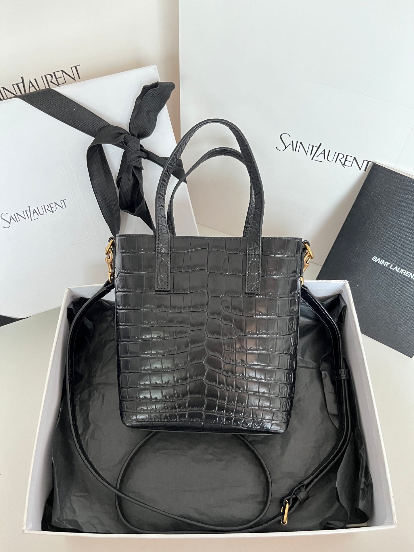 Black croc-embossed leather tote bag with detachable strap and gold hardware