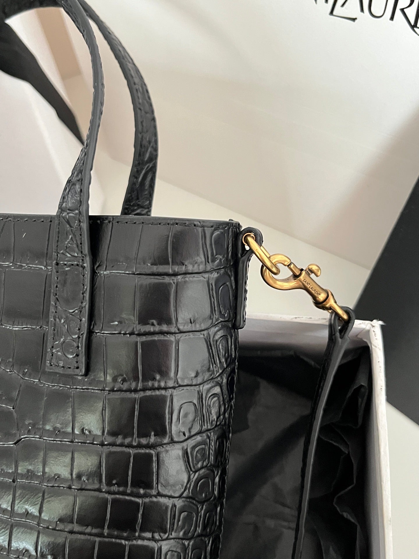 Black croc-embossed leather tote bag with gold-tone D-ring strap attachment