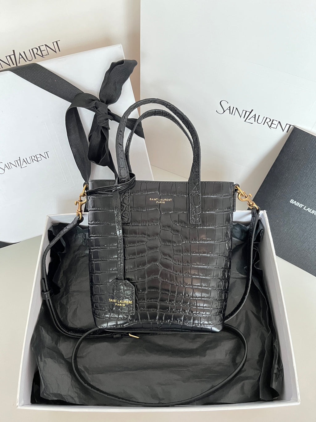 Black croc-embossed leather tote bag with top handles and gold-tone hardware