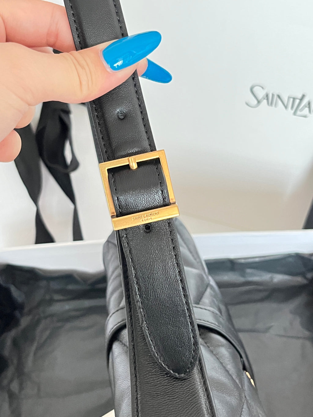 Leather bag strap with rectangular gold buckle and stitching detail
