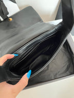 Dark leather bag interior with stitched zip pocket and open top section