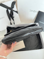 Quilted dark leather shoulder bag with long strap and smooth top edge