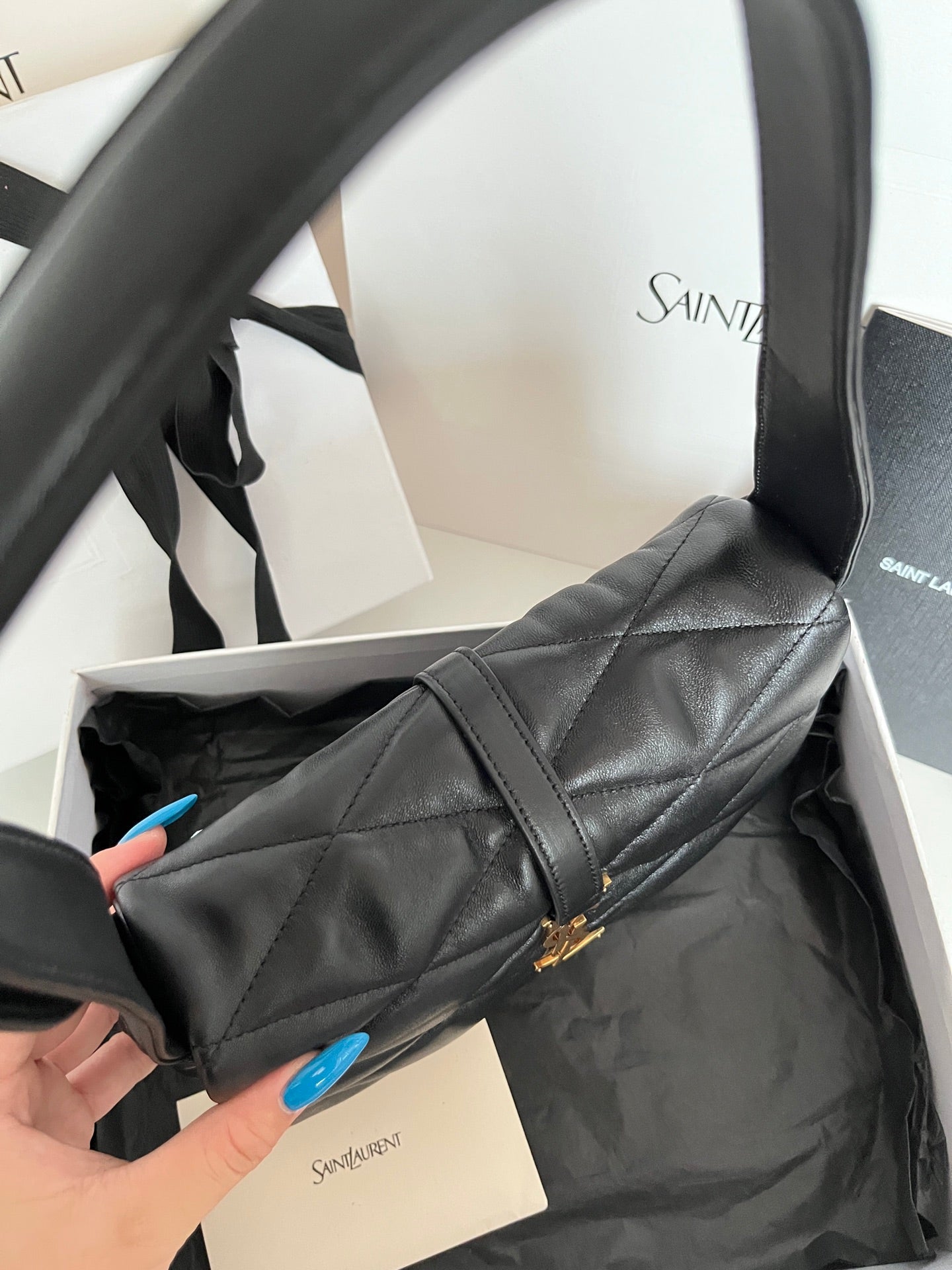 Quilted dark leather shoulder bag with gold YSL monogram on the side and top handle