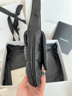 Quilted dark leather top-handle bag with front seam detailing and narrow shoulder strap