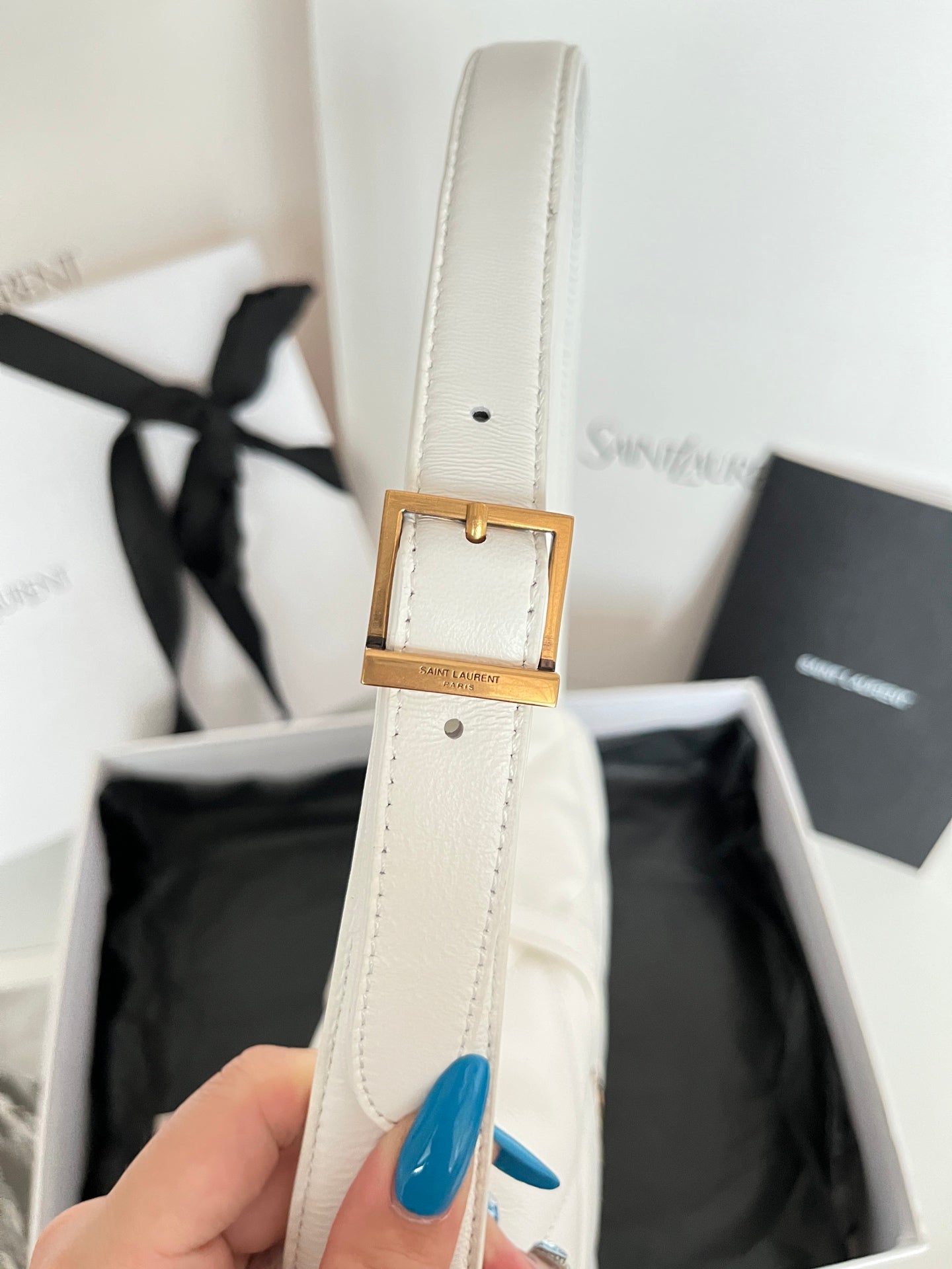 YSL quilted mini handbag, white, close-up of gold buckle on strap