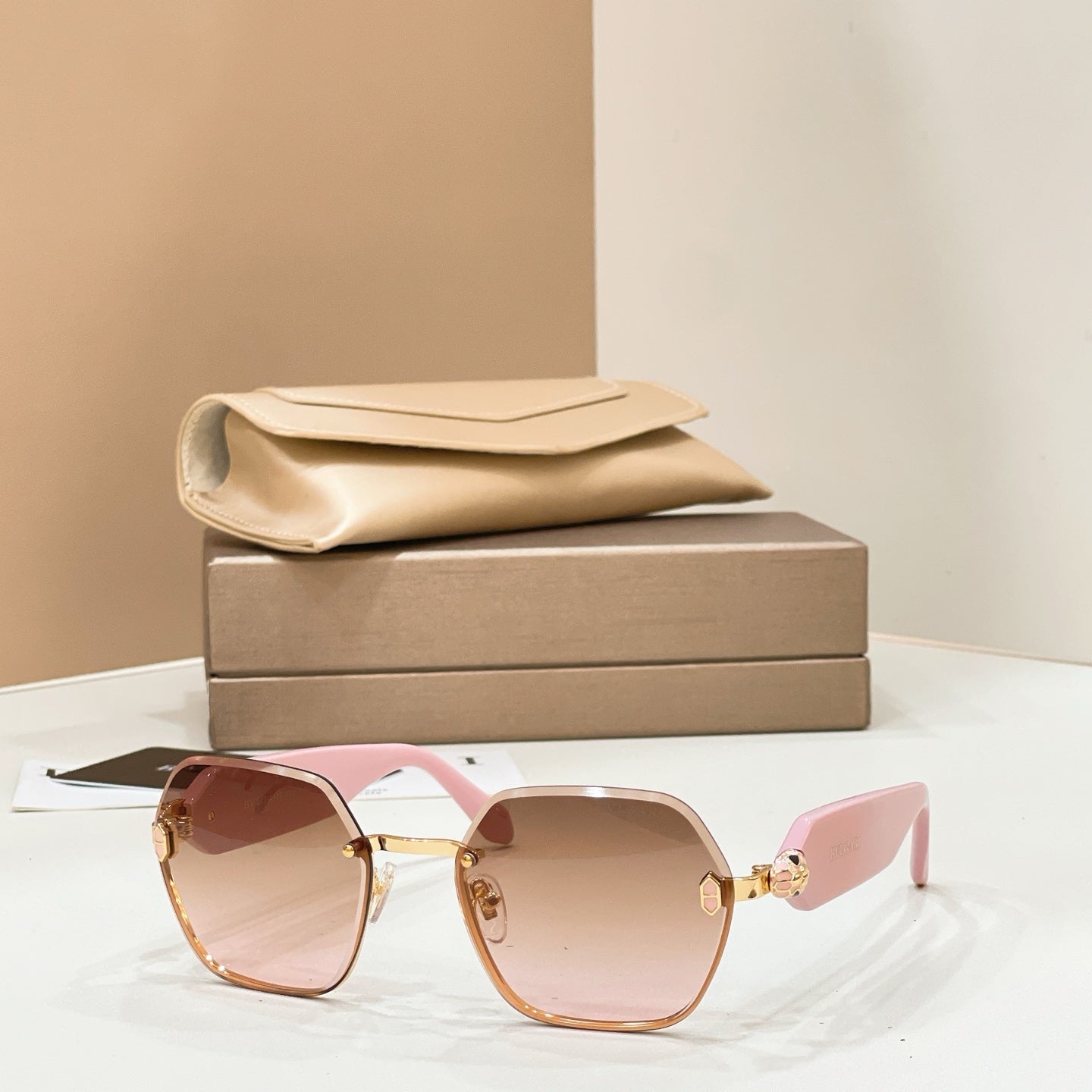 Bvlgari sunglasses with gold-tone frames and pink-tinted gradient lenses