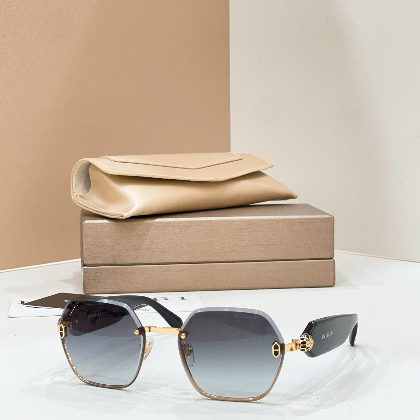 Bvlgari sunglasses with gold-tone frames and gray gradient square lenses