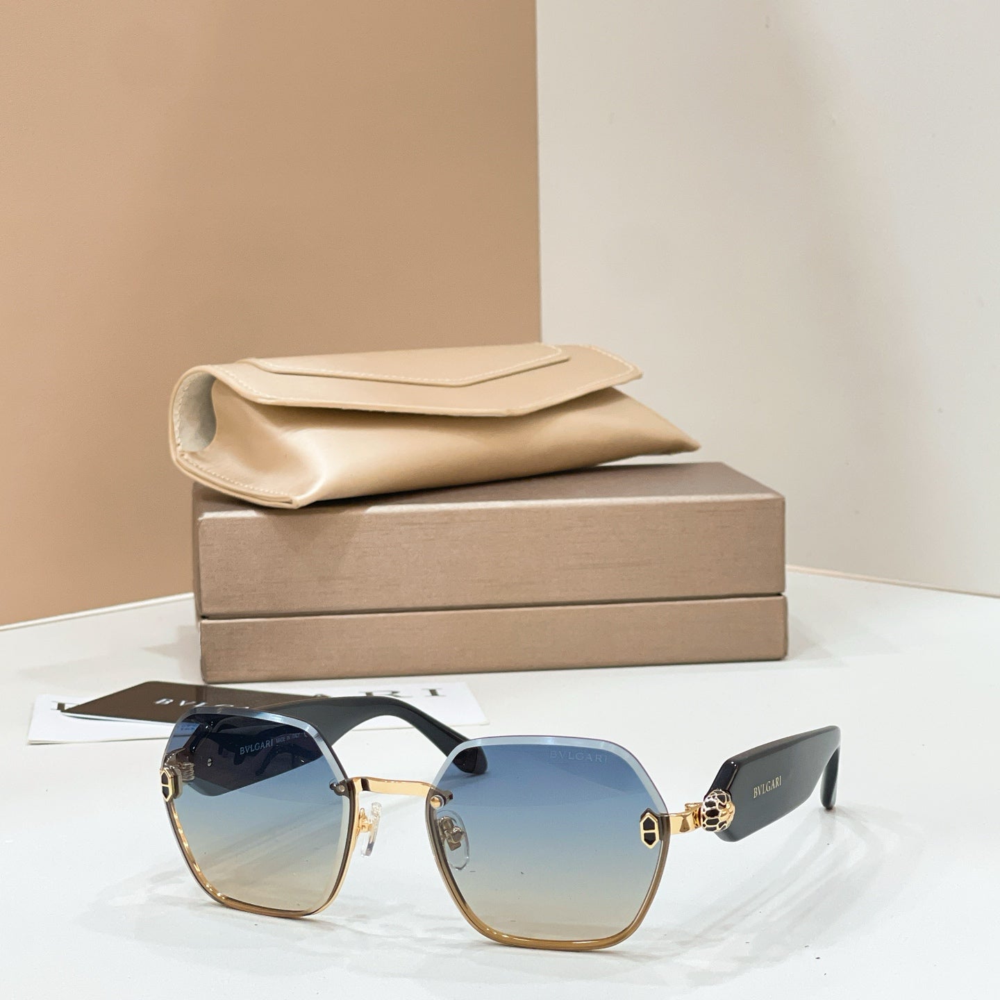 Bvlgari sunglasses with gold-tone frames and blue gradient square lenses