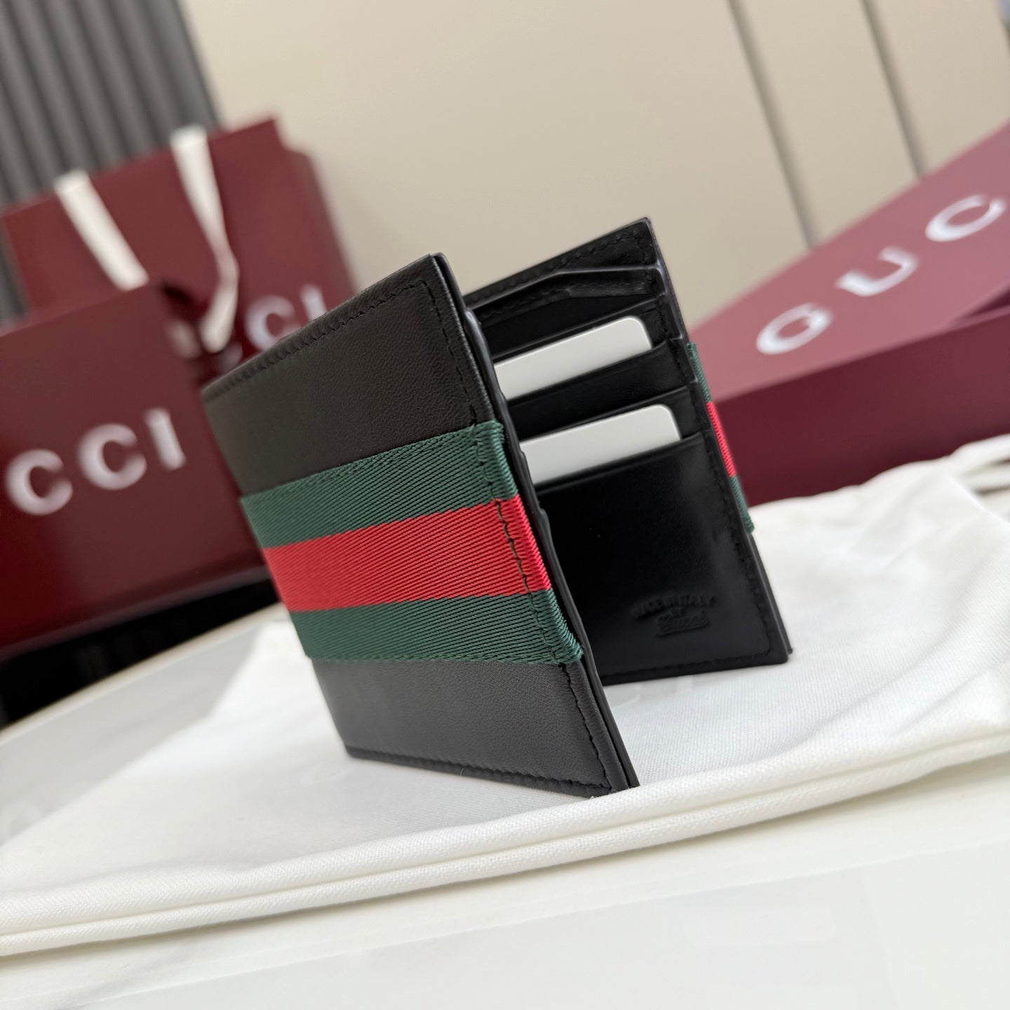 Gucci small leather wallet, open card slots view with green-red-green stripe band.