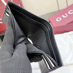 Gucci small leather wallet interior view, black lining and card slots.