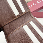 Gucci brown leather card wallet close-up with white stripe tabs and stitching