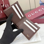 Gucci leather card case with brown exterior, white stripe details, open view