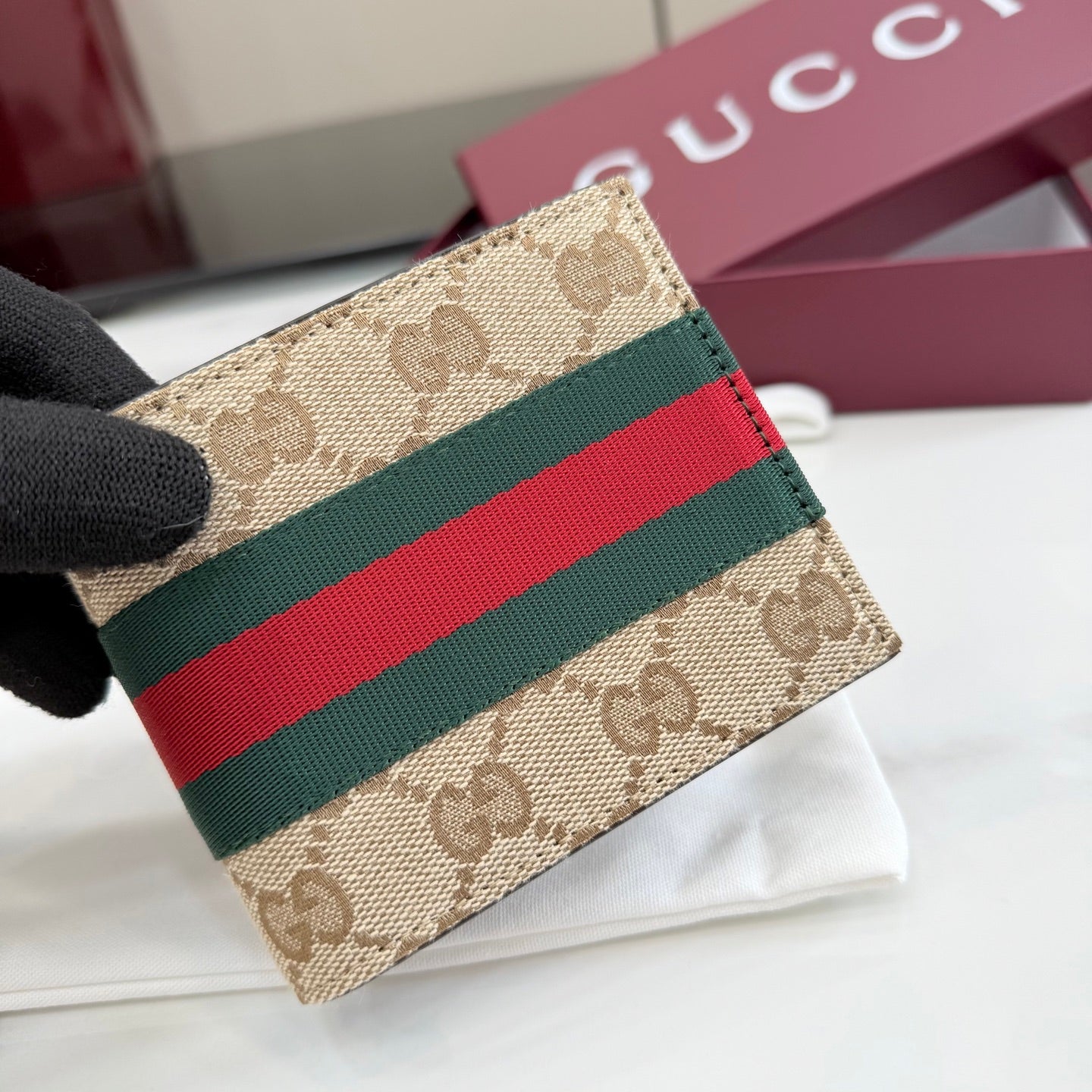 Gucci GG canvas card case close-up with green, red, and web stripe band