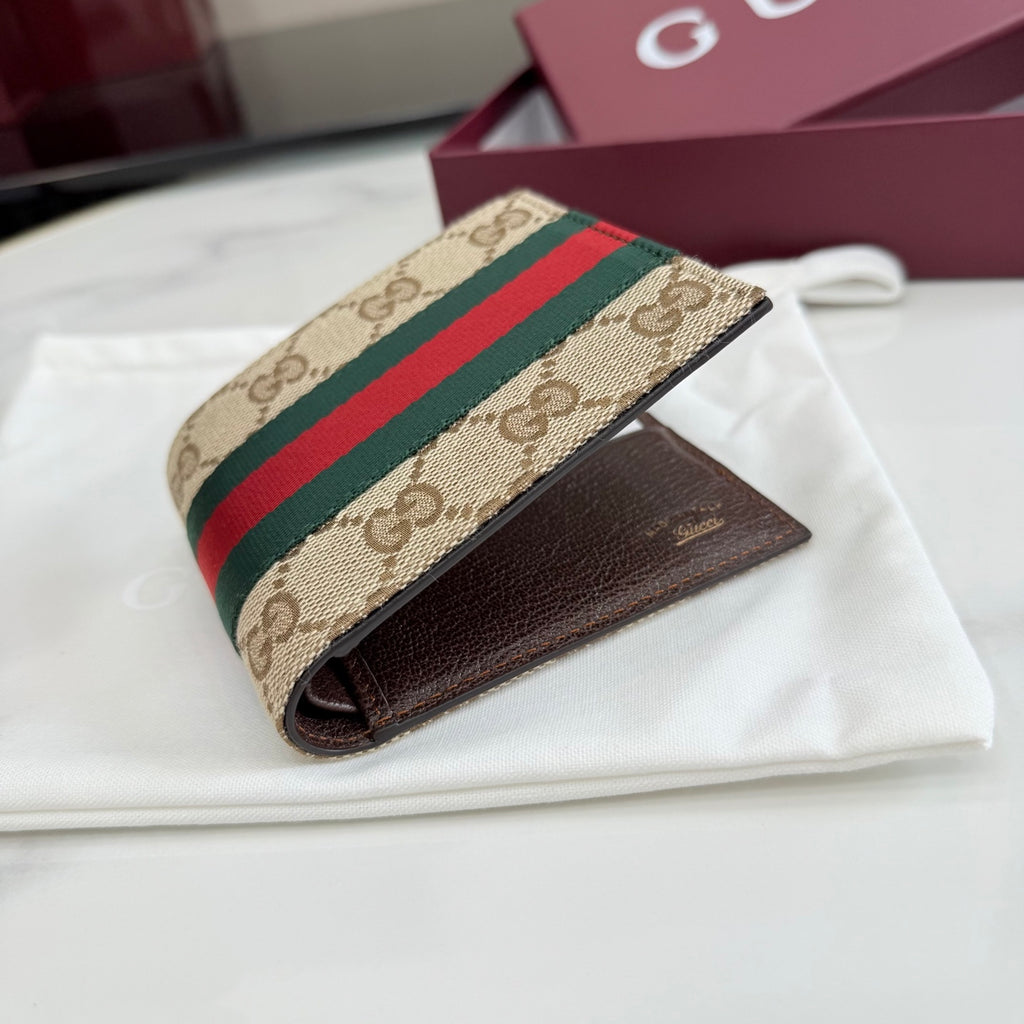 Gucci card wallet with GG canvas front and brown leather side, web stripe detail