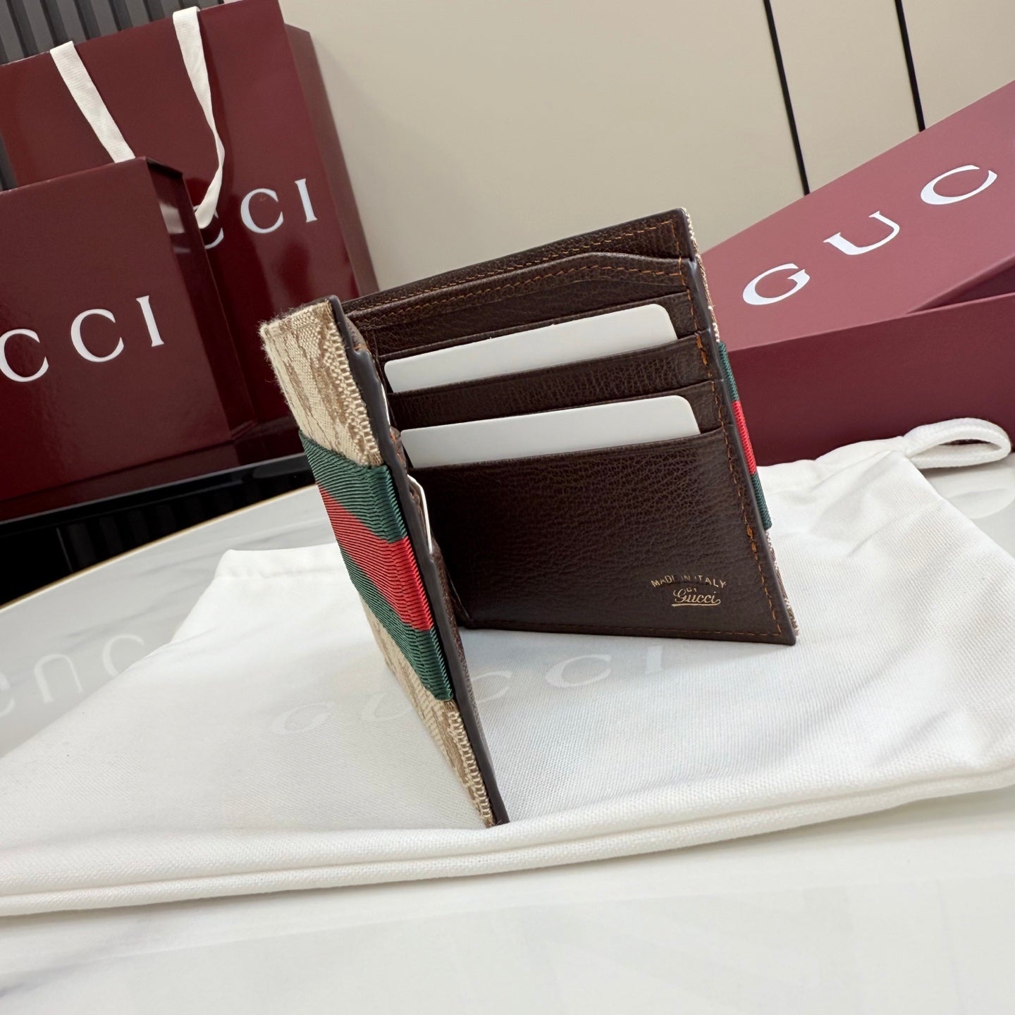 Gucci small card wallet open view with brown leather interior and card slots