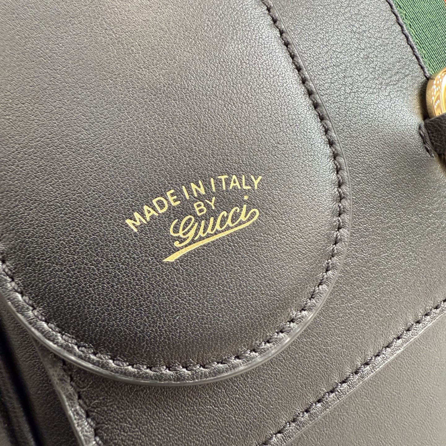 Gucci leather bag label, dark with MADE IN ITALY and Gucci logo stitch detail
