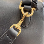 Gold-tone clasp on black leather Gucci bag strap