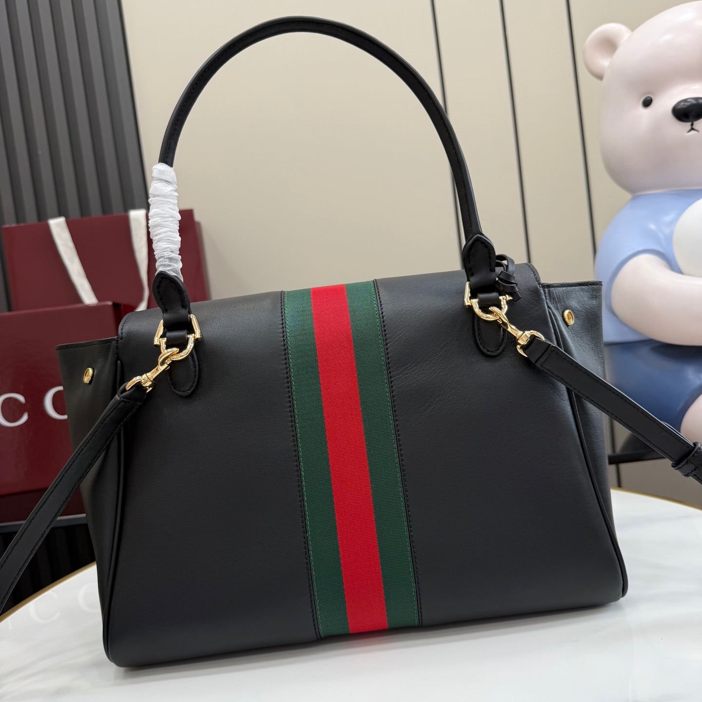Black leather Gucci tote bag with green and red web stripe and top handle