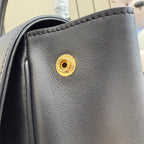 Gucci leather bag, black with gold clasp hardware close-up