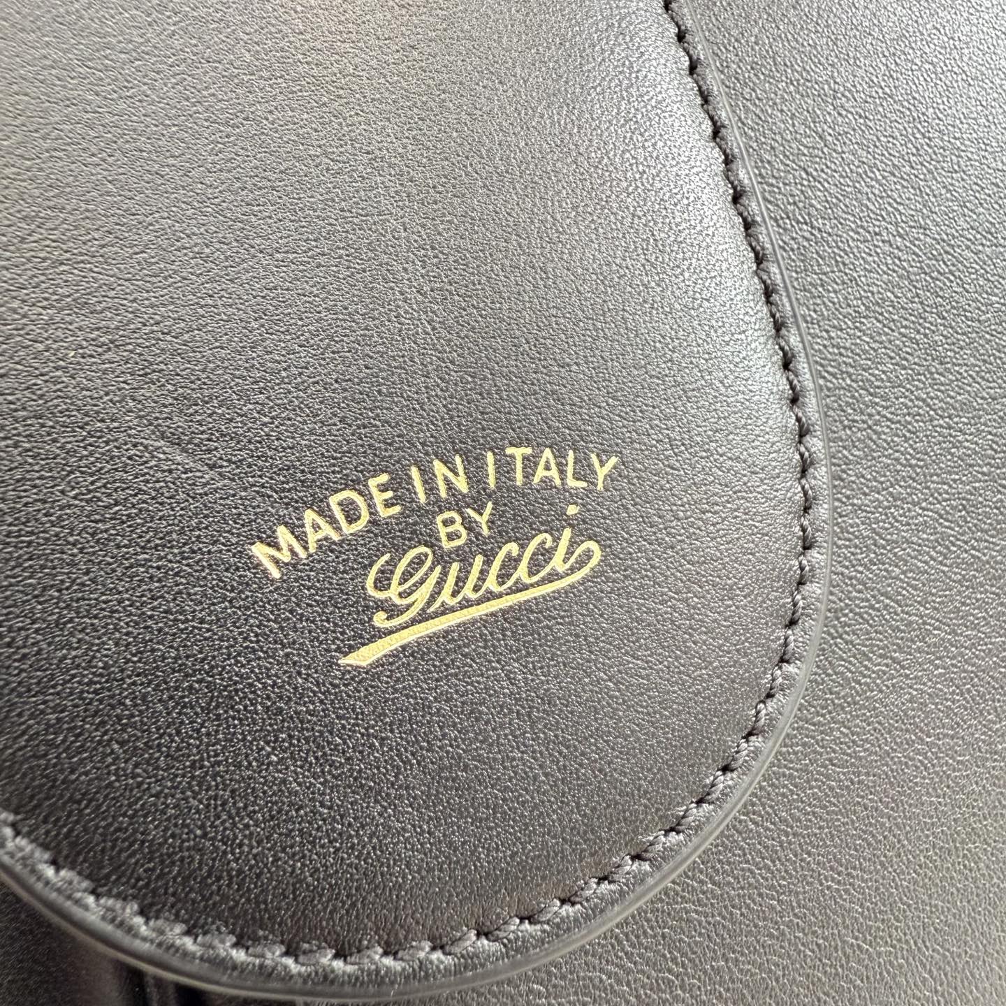 Gucci bag leather stamp reading “MADE IN ITALY” with Gucci logo