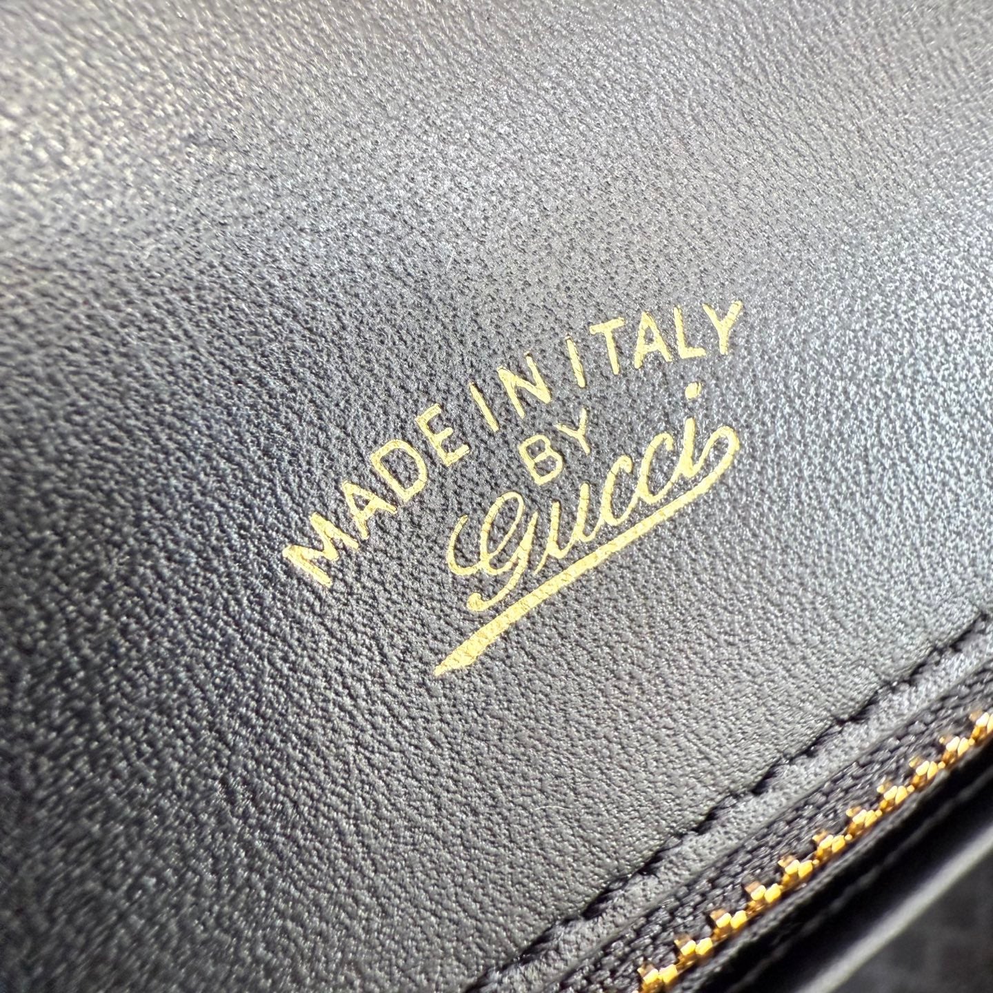 Gucci bag leather with gold 'Made in Italy' stamp and stitched edge