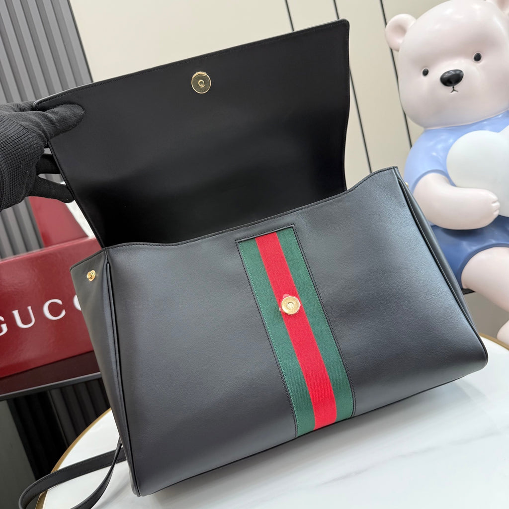 Gucci bag with dark leather and green-red stripe panel, open top interior