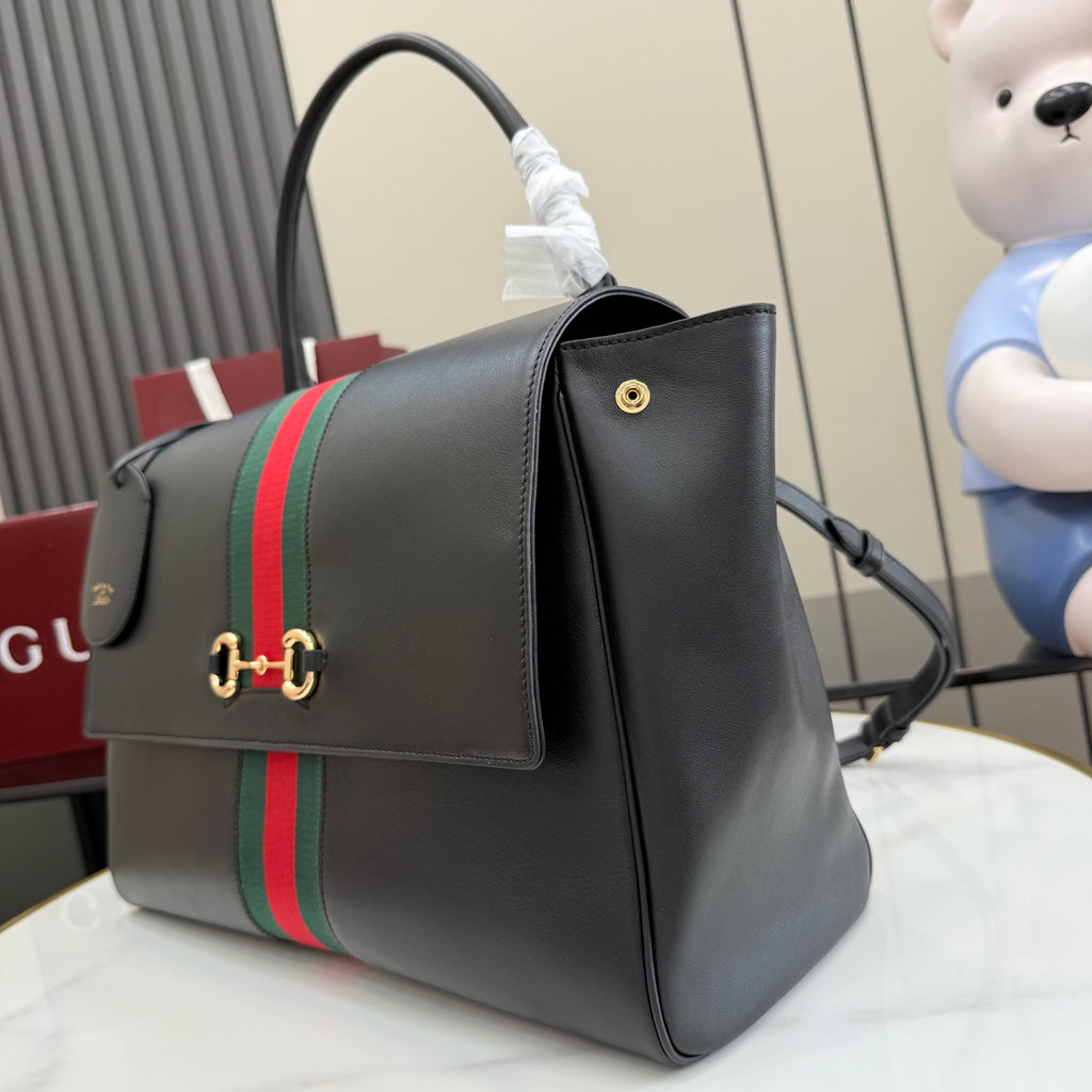 Gucci bag in dark leather with green-red stripe on back and gold hardware