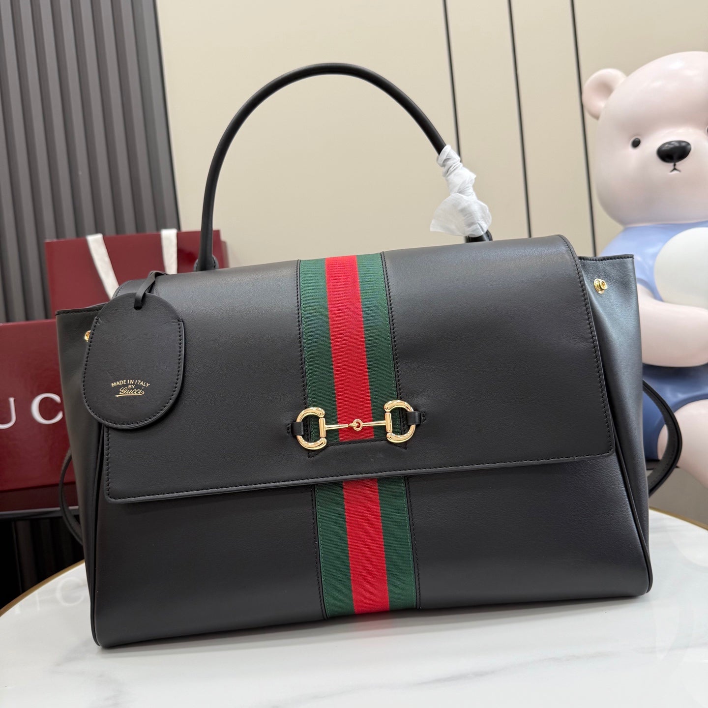 Gucci bag in dark leather with green-red stripe, flap and gold clasp