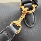 Gucci bag strap hardware with gold-tone buckle and ring on dark leather