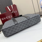 GG monogram duffel-style bag with top handle and adjustable shoulder strap.