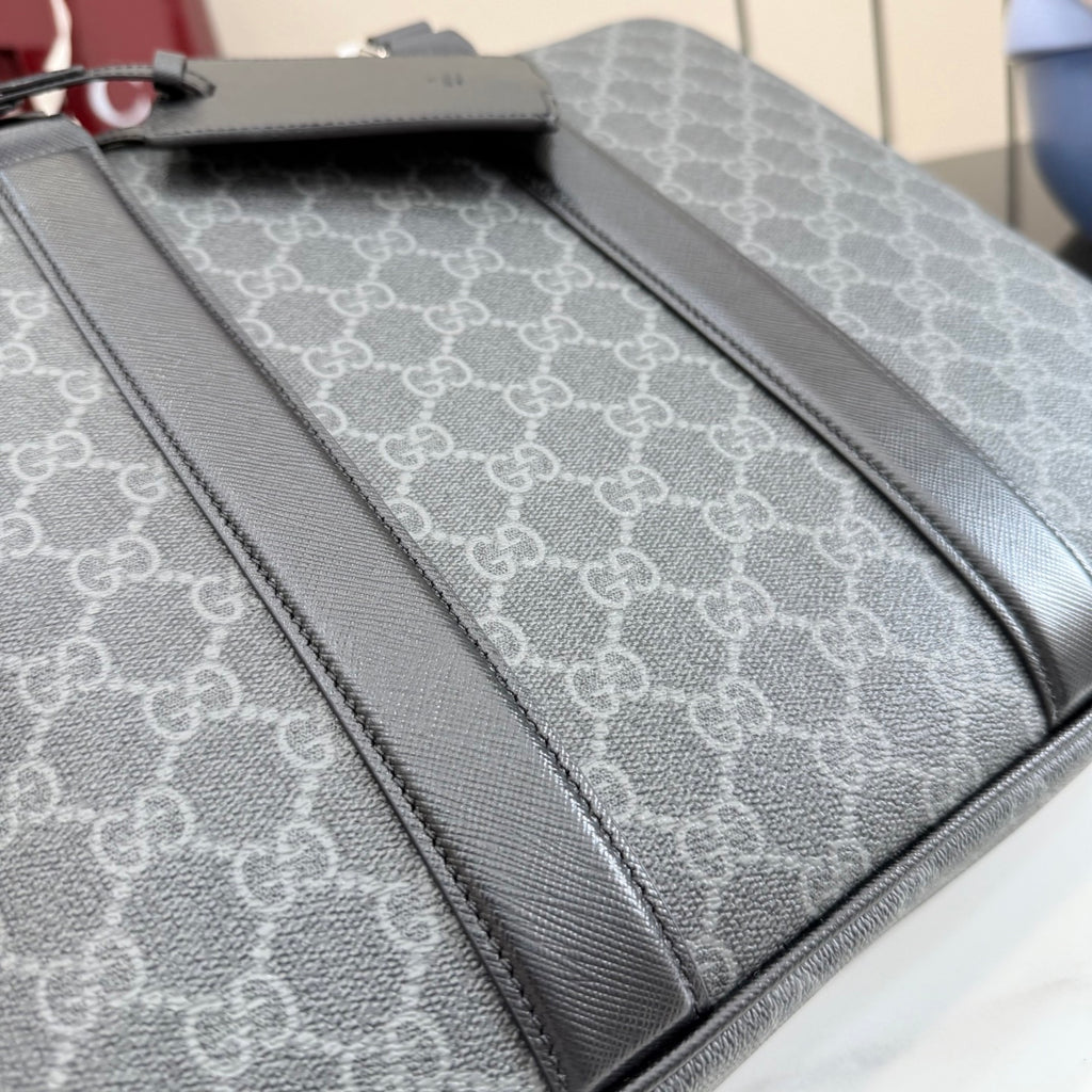 GG monogram bag interior panel with dark leather piping and stitched edge.