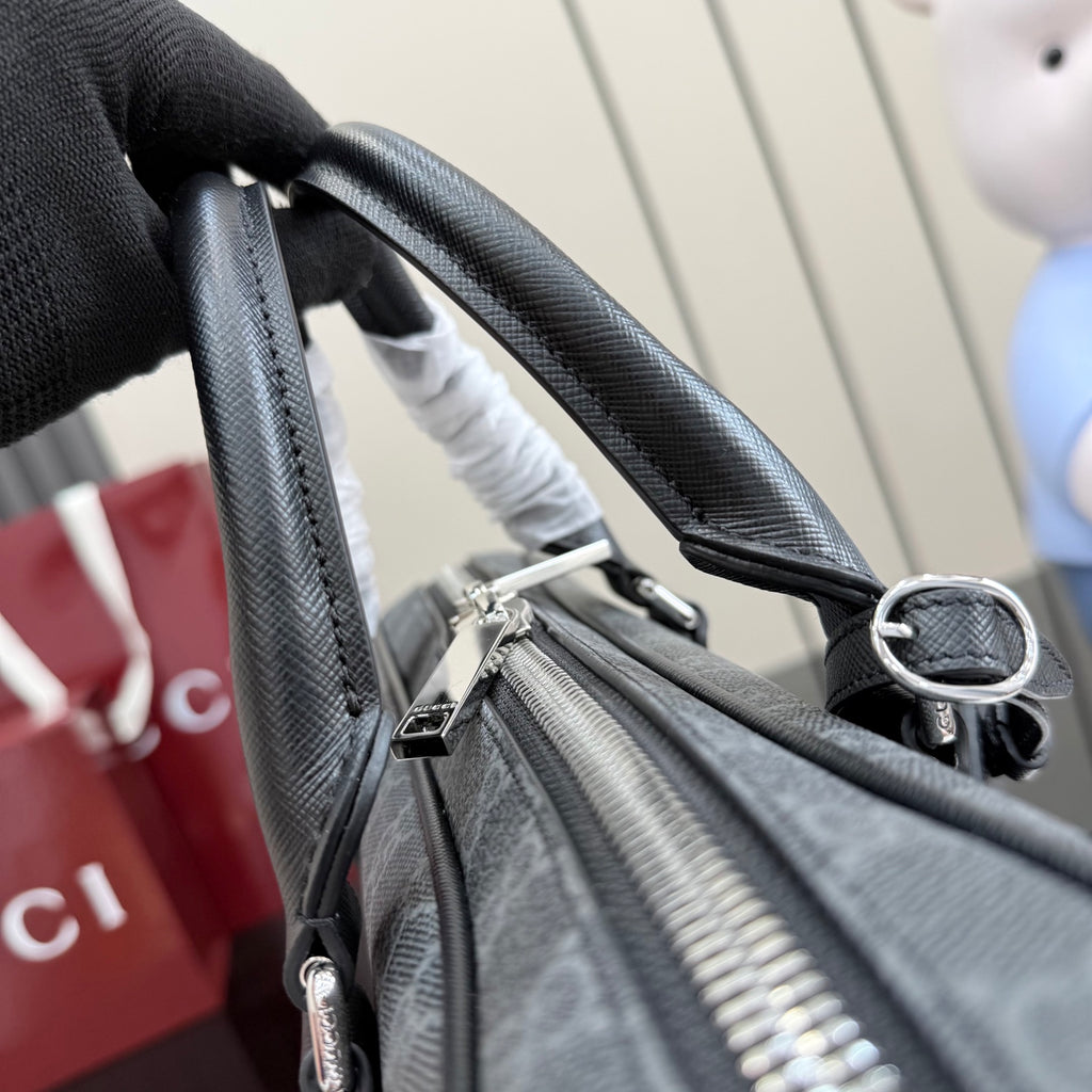 Top handle strap attachment on GG monogram bag with silver hardware and zipper track.