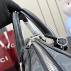 Top handle strap attachment on GG monogram bag with silver hardware and zipper track.