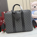 GG monogram top-handle bag with dark leather trim and front pocket detail.