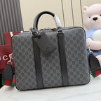 GG monogram top-handle bag with dark leather trim and front pocket detail.