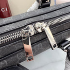 Front zipper pull hardware on GG monogram bag with metal tags and teeth track.
