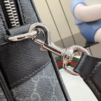 Gucci bag closeup: polished metal D-ring clip and textured dark leather strap